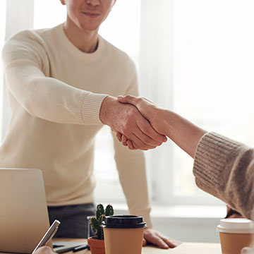 two people shaking hands for a construction project